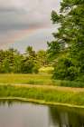 USA, Vermont, Otter Creek River Basin, Weybridge. Pond with rainbow and Green Mountains beyond. Art Print